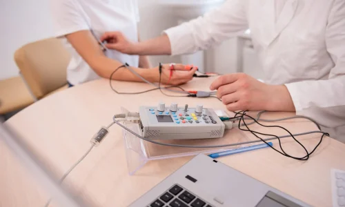 Patient nerves testing using electromyography at medical center.